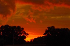 Storm clouds billow over the Fox River in Yorkville, Il at sunset