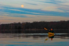Kayaking under a full moon in early spring on the Fox River in Yorkville, IL