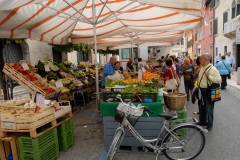 Street venders display various items for sale in the weekly street market in Sachille, Italy