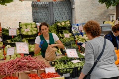 A vegetable vender in the street market in Sachille, Italy.  The weekly market has been a tradition in Sachille for centuries