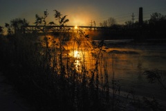 Sun rises through the mist of the Fox River in an especially cold day in Yorkville, IL