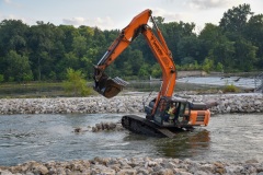 A track hoe arranges rock in the Marge Cline Whitewater course in Yorkville, IL