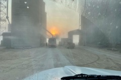 Fall sunrise highlights loading corn from a storage facility