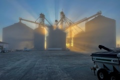 Sunrise behind a grain storage facility