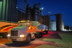 A grain truck is prepped before being shut down for the night