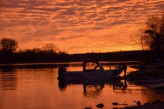 A boat being launched at daybreak on the Fox River near Yorkville, IL